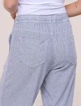 Pantalón de lino de calce holgado y caída ligera, con estampado de rayas verticales en tonos celestes y blancos. Cuenta con cintura elastizada fruncida con cordón ajustable al frente, bolsillos laterales y pierna recta.