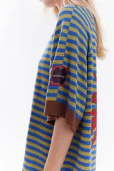 Vestido corto de tejido de punto con diseño de rayas horizontales en tonos rojo y rosado, con detalles en color marrón en el cuello, puños y ruedo. Presenta un ajuste relajado, mangas cortas y detalle de bordado frontal.