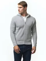 Campera tejida con capucha, confeccionada en poliéster, con cierre frontal completo y diseño de punto acanalado.