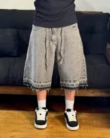 Bermuda de jean gris con efecto lavado, corte amplio, cordón ajustable en la cintura y terminación desflecada.