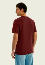 Remera blanca de corte regular y manga corta, con estampa frontal inspirada en un club de pesca en tonos azul y rojo.
