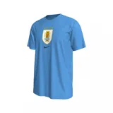 Remera Nike de la Selección Uruguaya de Fútbol (AUF), color celeste, manga corta y cuello redondo. Presenta el escudo de la AUF con cuatro estrellas arriba y el logo de Nike en negro en el pecho.