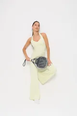 Conjunto deportivo de dos piezas en color amarillo limón, compuesto por un top de escote redondo con espalda estilo nadadora y un pantalón de corte acampanado con cintura alta.