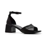 Sandalia de cuero color blanco hueso, con tira delantera cruzada, pulsera al tobillo con hebilla metálica y taco cuadrado.