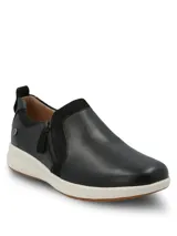 Zapatillas slip on Hush Puppies modelo Spinal Slip On, color negro, confeccionadas en cuero con detalles de gamuza y cierre lateral decorativo. Poseen suela blanca y base de goma con tecnología TripleDensity para mayor amortiguación y soporte.