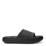 Chanclas tipo slide de la marca Miss Carol, con diseño minimalista y suela de plataforma. Presentan una textura grabada en toda la superficie y el logo de la marca en relieve sobre la banda superior.