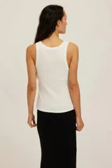 Musculosa blanca de tejido de canalé ancho, con escote redondo y silueta ajustada.