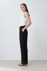 Pantalón negro de corte amplio con bordado de boderie y lazo de ajuste en la cintura.