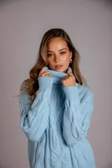 Suéter tejido de punto trenzado color salmón, con cuello alto y mangas largas. Corte ajustado al cuerpo.