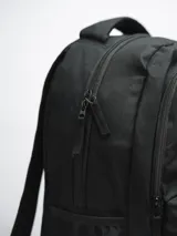 Mochila negra con tres compartimentos con cierre y dos bolsillos laterales abiertos con elástico.