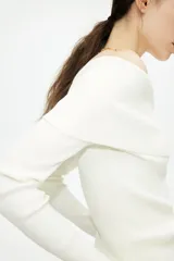 Top blanco de manga larga en tejido de punto acanalado, con escote Bardot (hombros descubiertos) y borde doblado.