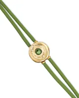 Pulsera de cuero verde con doble tira, dije central dorado con forma de ojo y cristal verde.