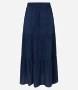 Pollera midi azul marino con estampado de lunares blancos, cintura elástica con lazo y volados.