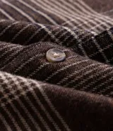 Camisa de manga larga confeccionada en franela de algodón, con cuello bowling y cierre frontal de botones. Presenta un diseño de estampado a cuadros en tonos marrones y beige, con un corte regular tradicional.