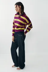 Jersey de punto con diseño de rayas horizontales en colores violeta y verde lima, cuello polo con escote en pico y manga larga con puños ajustados.