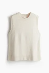 Chaleco de punto fino con lana, de corte holgado, cuello redondo y terminaciones acanaladas en cuello, sisas y bajo.