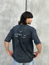 Remera oversize gris con efecto lavado y estampado en la espalda con la frase "STORIES OF THE EAST".