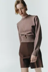 Shorts de tiro alto color marrón oscuro, con pinzas en el delantero y espalda, y cierre con cremallera metálica a contraste en la espalda.