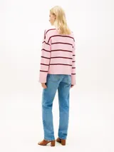 Sweater de punto Tommy Hilfiger confeccionado en puro algodón peinado, de diseño amplio y hombros caídos con rayas horizontales rosadas y burdeos. Cuenta con cuello redondo y logo en fuente Script bordado en el pecho.