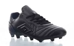 Championes de fútbol Umbro modelo Touch FG, color negro, diseñados para césped natural firme. Presentan una parte superior de piel sintética resistente con costuras decorativas y el logo de la marca en el lateral. Cuentan con suela de tacos de plástico para mayor tracción y estabilidad.