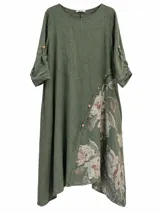 Vestido midi verde militar de corte asimétrico, con mangas 3/4 con presillas y botones, cuello redondo y estampado floral en la parte inferior y lateral.