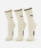 Pack de tres pares de medias largas Puma de algodón, color blanco crudo con detalles en marrón y negro, incluyendo líneas en el elástico superior, el logo del felino y la inscripción de la marca en el lateral.