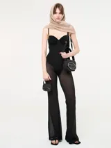 Mono negro de Diesel con corset y transparencias en las piernas. Breteles finos regulables y cierre en la espalda.