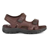 Sandalias de cuero marrón con ajuste de velcro en el empeine y tobillo, suela de goma negra y plantilla acolchada.