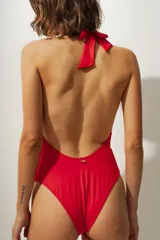 Traje de baño entero rojo con escote halter y nudo en el centro.