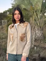 Camisa color beige de tejido de punto fino con apliques de cuero en cuello, hombros y bolsillos.