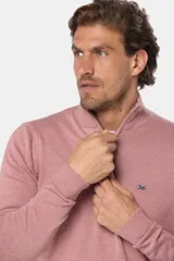 Buzo de tejido fino en hilo de algodón, color rosado, con cuello alto y cierre frontal parcial con detalle en cuero. Presenta puños y ruedo acanalados y un pequeño logo bordado en el pecho.