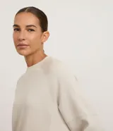 Buzo de corte regular confeccionado en modal, con cuello redondo, mangas largas y costuras decorativas visibles. Presenta un diseño minimalista y versátil.