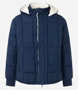 Campera puffer de hombre reversible, con diseño acolchado, cuello alto, capucha y cierre frontal.