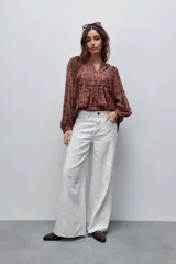 Jean wide leg de tiro alto en color crudo, con corte amplio y pierna extra ancha, confeccionado en algodón con costuras visibles.