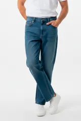 Pantalon de jean estilo baggy con calce medio y corte recto. Presenta un lavado azul clásico con costuras reforzadas y cierre frontal con botón metálico.