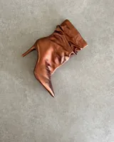 Botín de cuero vacuno color cobre, con taco aguja de 9cm y caña arrugada.