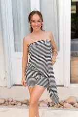 Conjunto de dos piezas en color beige, compuesto por un top strapless con corte asimétrico y un pantalón de corte recto y holgado.