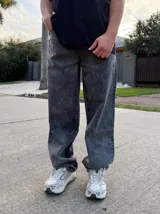 Pantalón de jean estilo baggy, de corte holgado y tiro medio, confeccionado en denim de tela pesada en tono celeste claro.