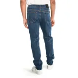 Jeans de corte slim en denim azul con efecto lavado, cierre de cremallera y botón, diseño de cinco bolsillos y detalles de la marca CAT.
