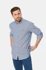 Camisa de lino color beige con cuello mao, manga larga, cierre frontal de botones y bordado sutil en el pecho.