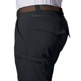 Pantalon de trekking convertible a short, color negro, con múltiples bolsillos laterales y cierre de cremallera en las piernas. Confeccionado en tejido técnico con tecnología de protección solar y gestión de la humedad.