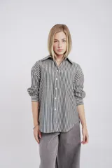 Camisa a rayas verticales grises y blancas, de corte recto y mangas largas.