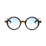 Lentes de sol circulares con marco carey en tonos marrones y beige, y cristales degradados en tono celeste.