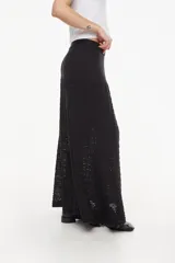 Falda larga de tejido artesanal negro, con diseño fluido y detalles calados.