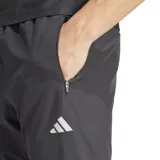 Pantalón deportivo Adidas Run It TKO, color negro, con ajuste ceñido, cintura elástica con cordón ajustable y cierres en los tobillos. Presenta el logo de Adidas en blanco en el muslo izquierdo.