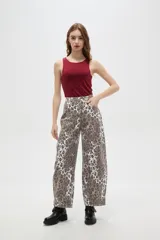 Pantalon tipo jean de corte barrel y tiro bajo, con estampado animal print de leopardo en tonos marrones y blancos.