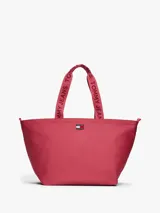 Cartera tipo tote de Tommy Jeans, confeccionada en poliéster con acabado liso. Presenta un compartimento principal con cierre de cremallera, asas superiores con la inscripción de la marca y el parche distintivo de Tommy en el frente.