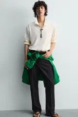 Polo de manga larga color rojo, confeccionado en tejido de algodón con estructura piqué, cuello solapa y cierre frontal de botonadura. Presenta aberturas laterales en el bajo.