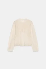Camisa de algodón color crudo con cuello redondo y cierre de lazada en la espalda. Presenta mangas largas con puños, tablas y detalles de bordados y entredoses en el frente.