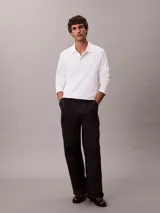 Chomba de manga larga Calvin Klein confeccionada en algodón interlock, con cuello clásico, cartera con botones y logo bordado en el pecho.